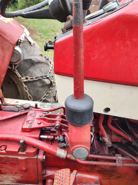 Stick a bar in hole and move the shift fork on left as when seated to rear so all three fork notches line up in the middle of the guide notches. . International tractor stuck in gear